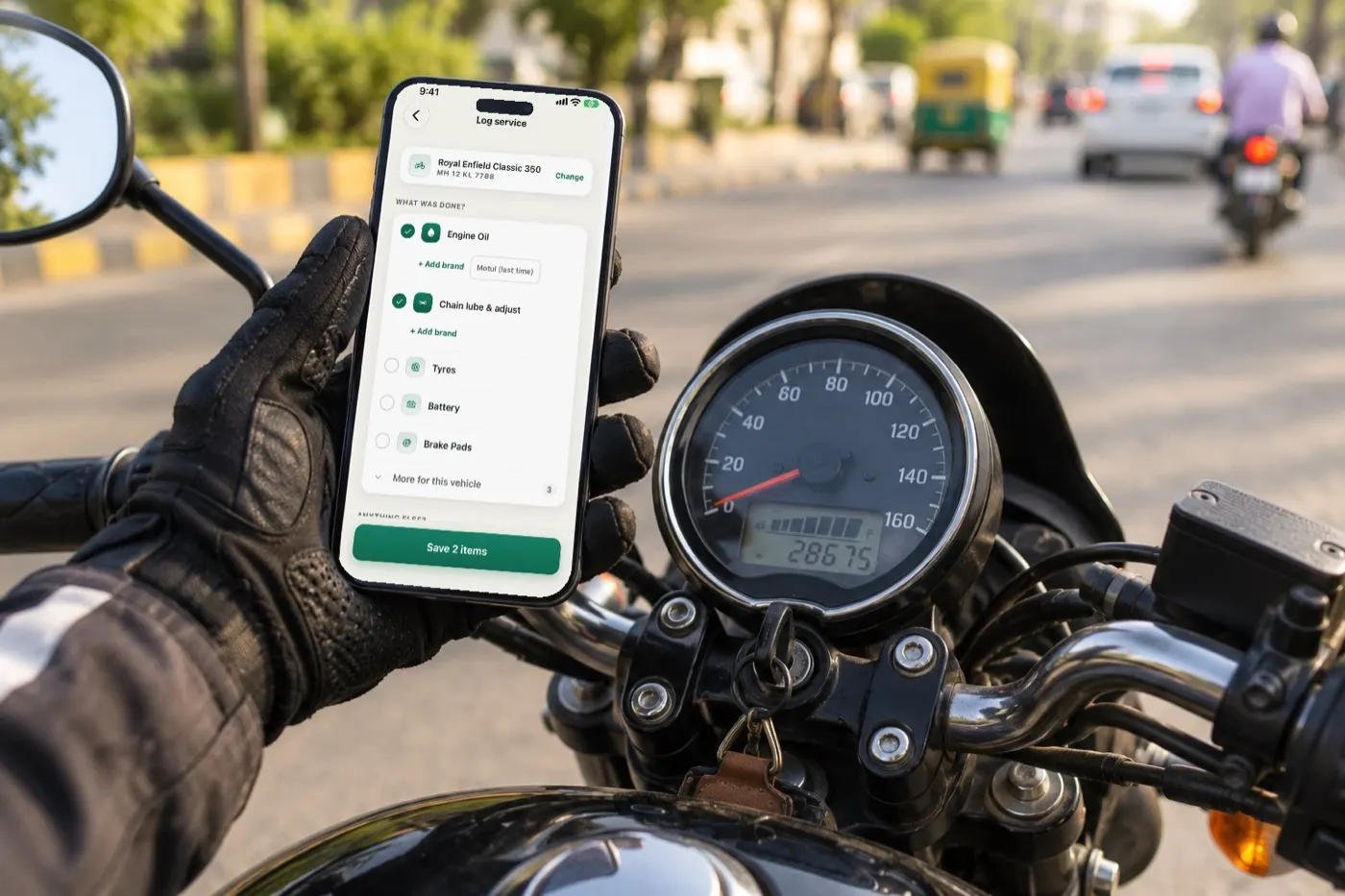 A rider holding a phone with MotorBabu's Log service screen next to a motorcycle's speedometer