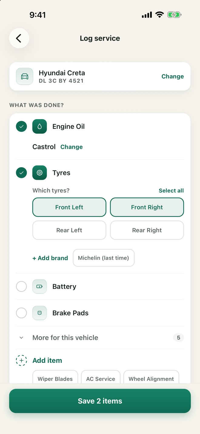 The Log service screen: Engine Oil and front tyres ticked, ready to save 2 items